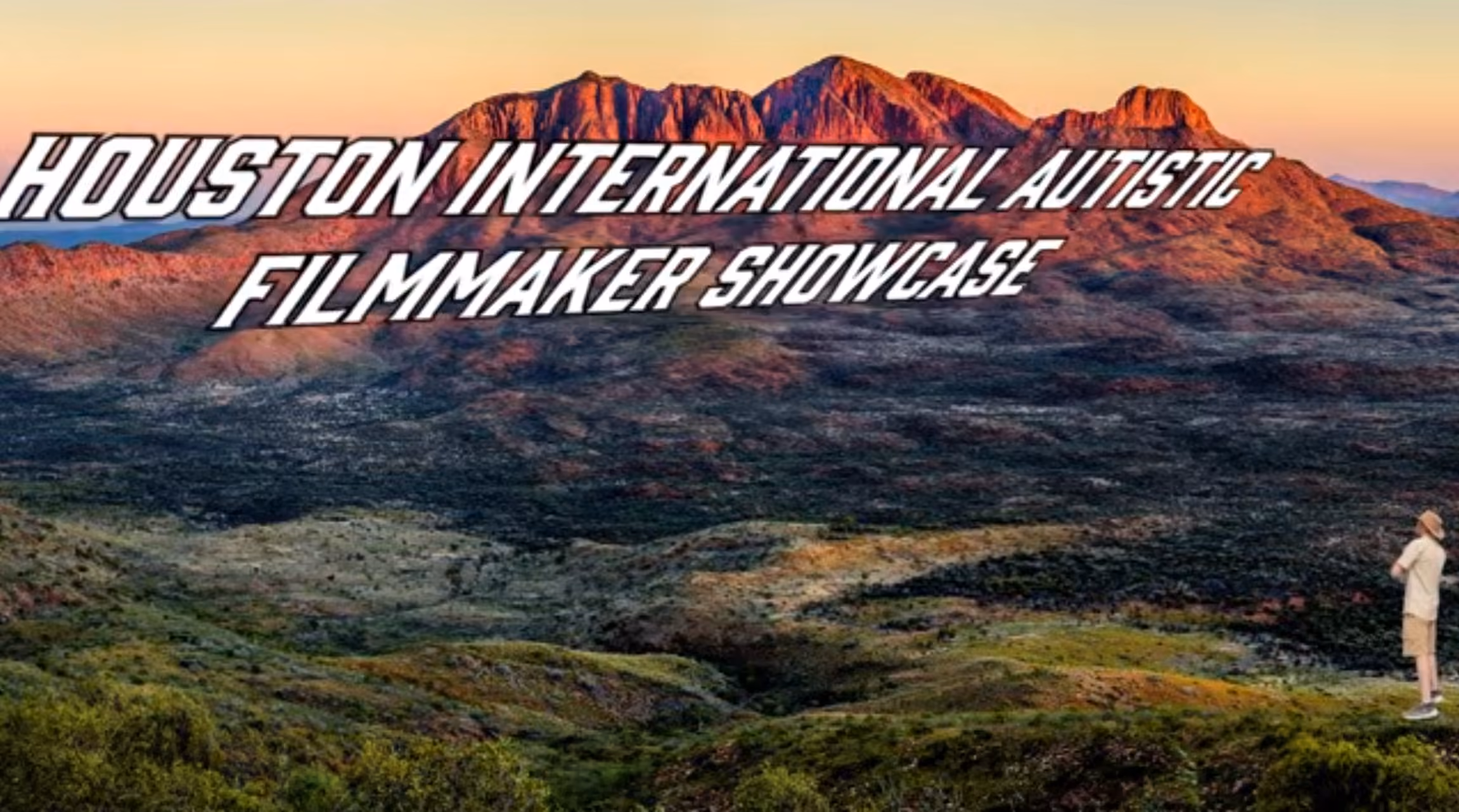 Scenic mountain landscape at sunset with large text overlay reading 'Houston International Autistic Filmmaker Showcase' and a person standing on the right edge looking at the view.