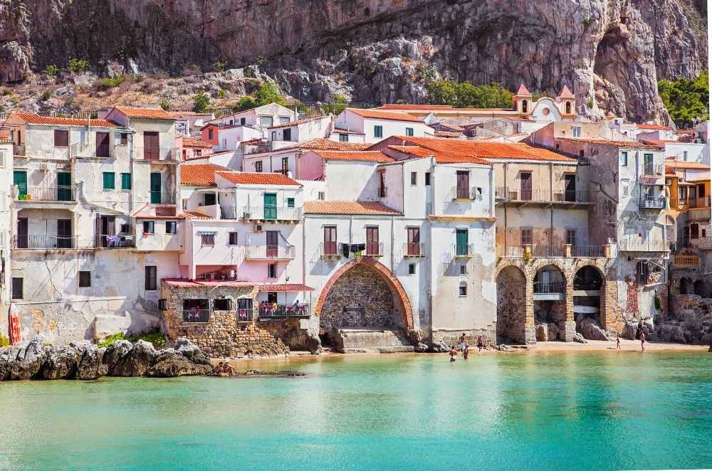 View of Cefalù’s old town and coast, a must-see stop on a private coach tour in Sicily.