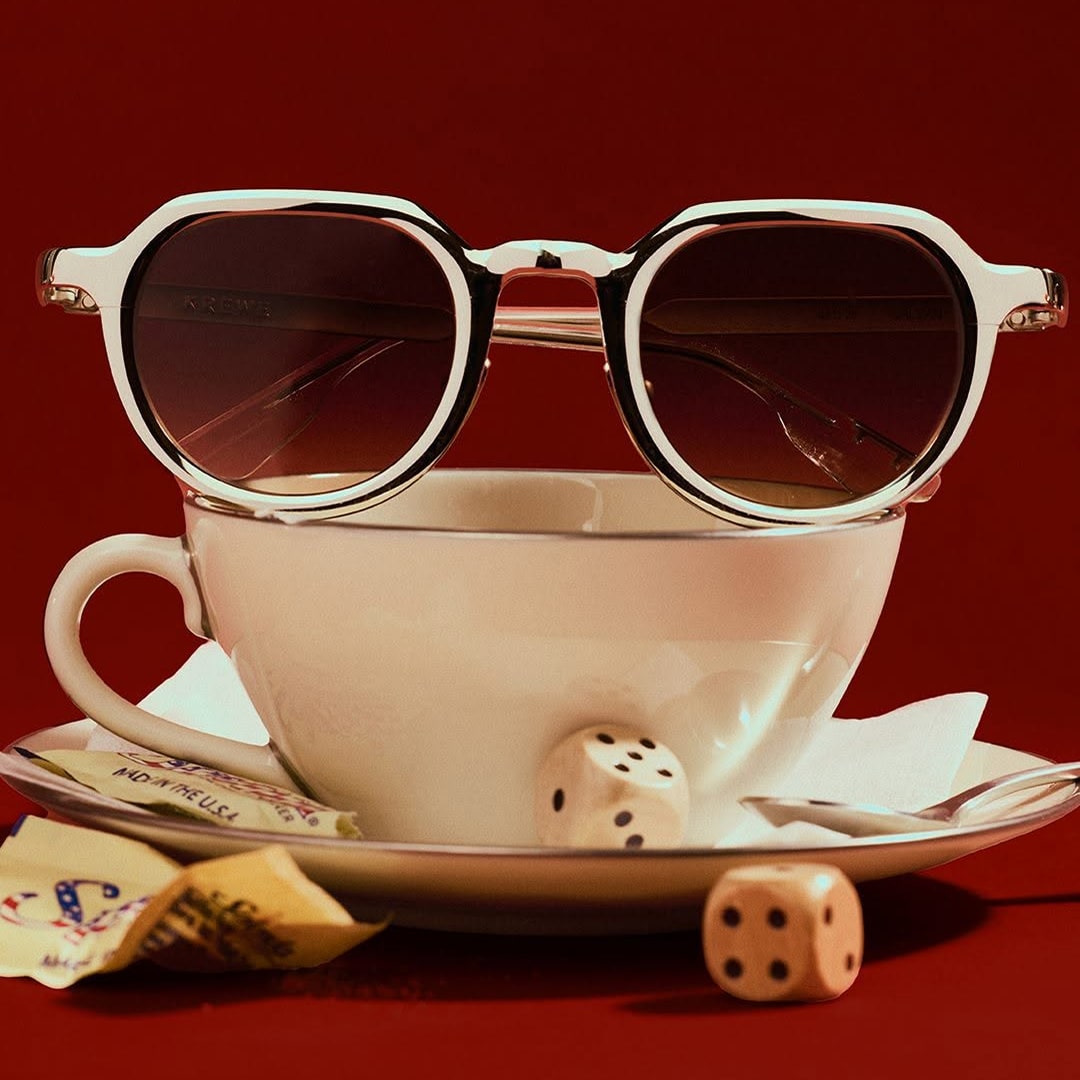 Lifestyle eyewear photography featuring sunglasses styled on a coffee cup
