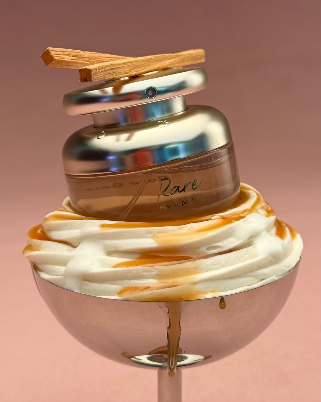 Luxury cosmetic jar with gold accents styled on a soft pink background