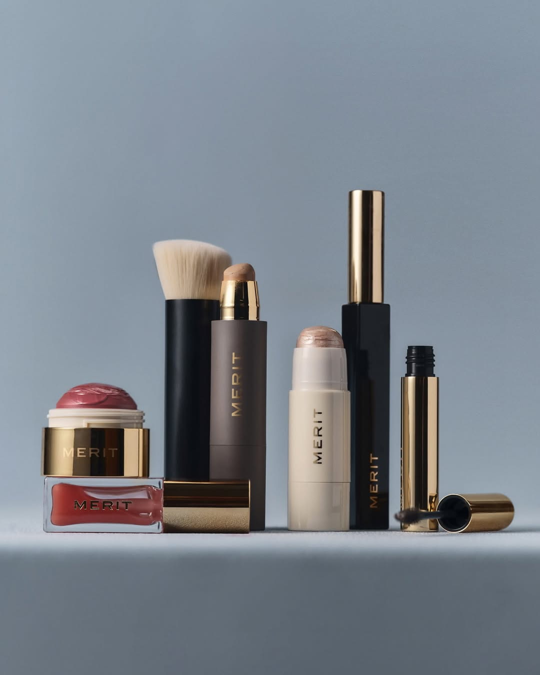Minimal makeup product lineup photographed on a clean studio background