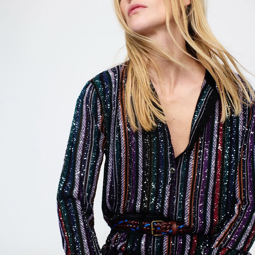 Striped blouse photographed on model showing lightweight flowing fabric and vertical pattern