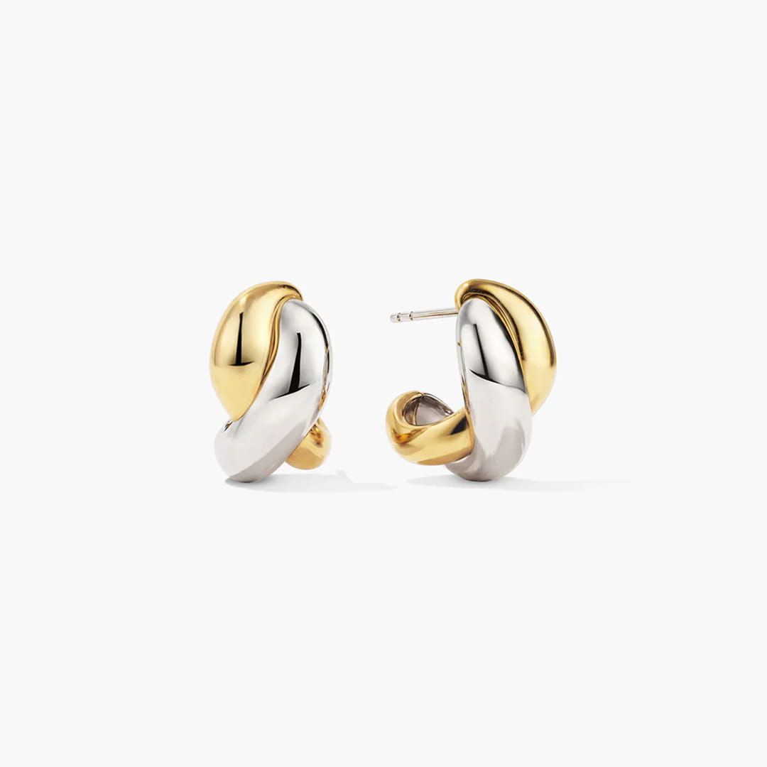 Two-tone gold and silver chunky hoop earrings, white background