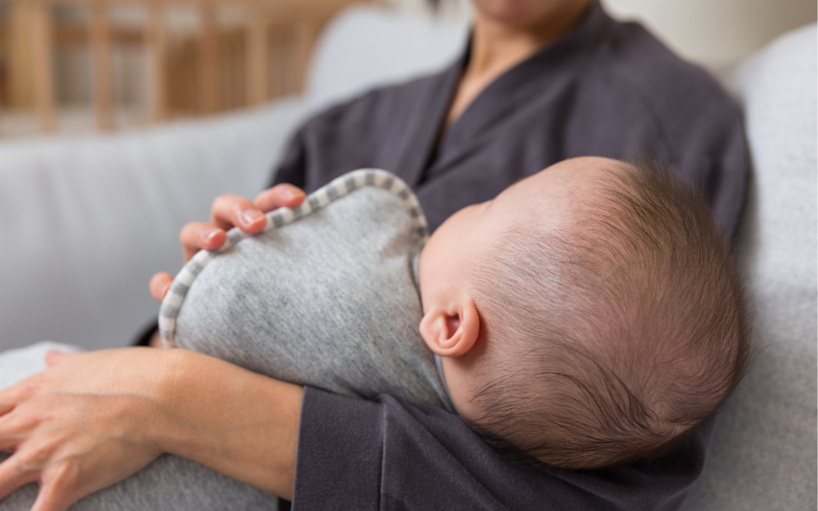 baby relaxing with mom