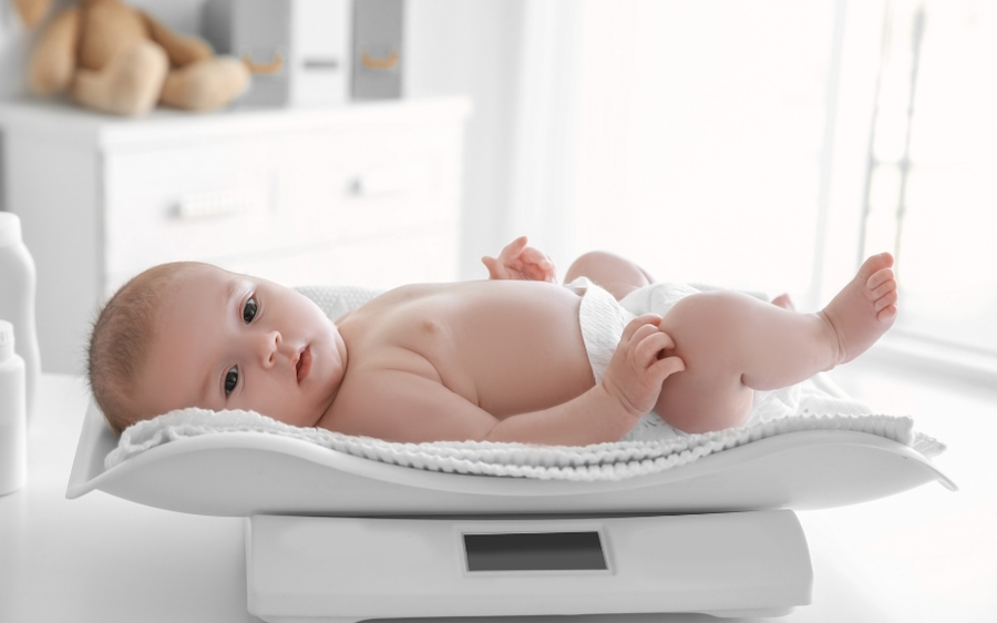 baby laying on baby scale