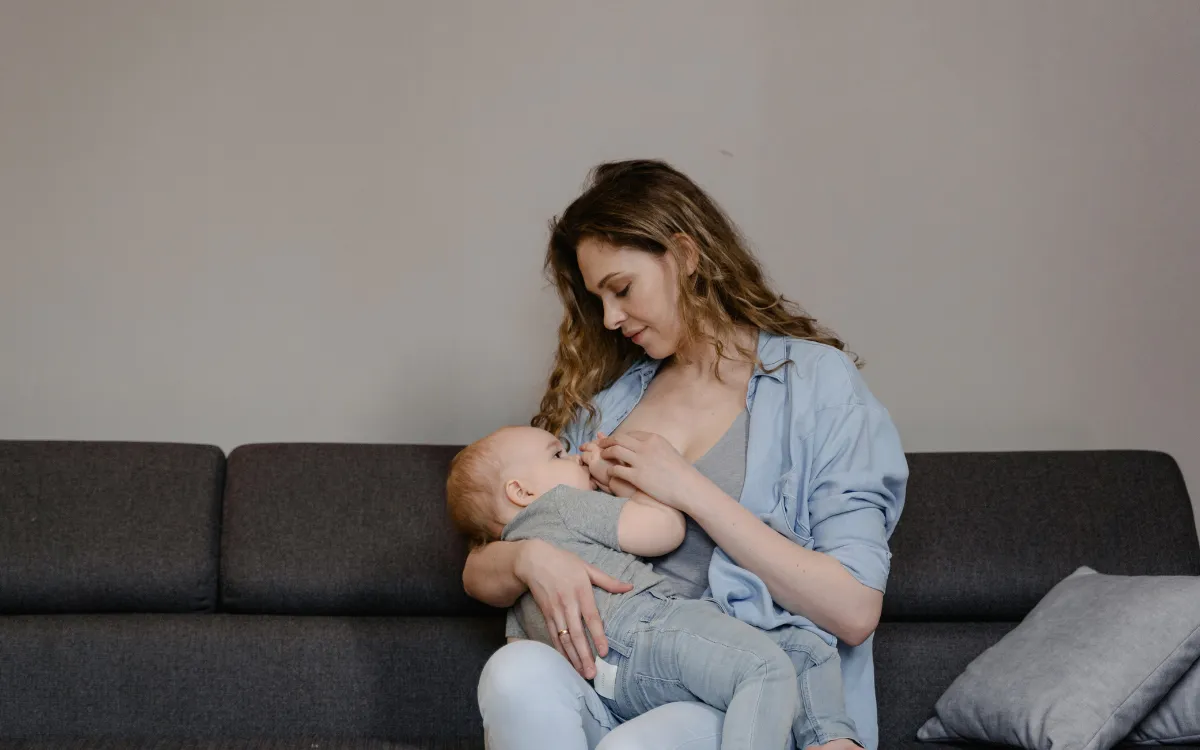 woman breastfeeding baby and thinking about when she should get help for engorgement