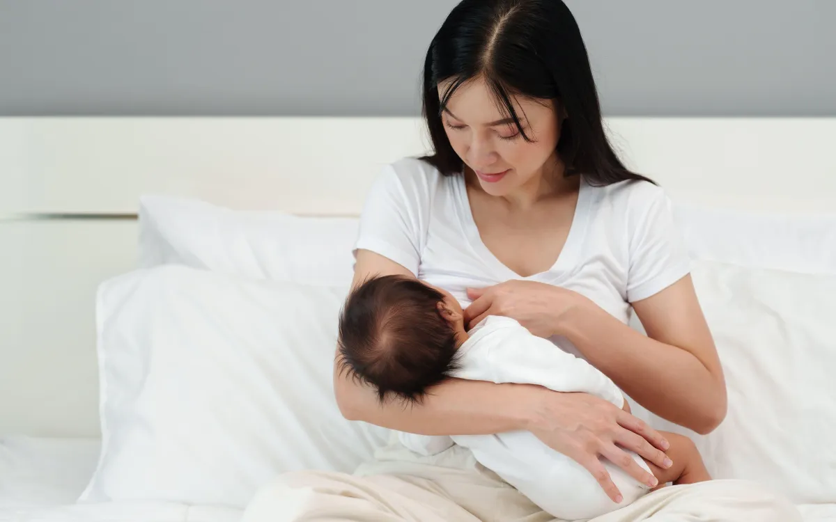 woman breastfeeding newborn baby
