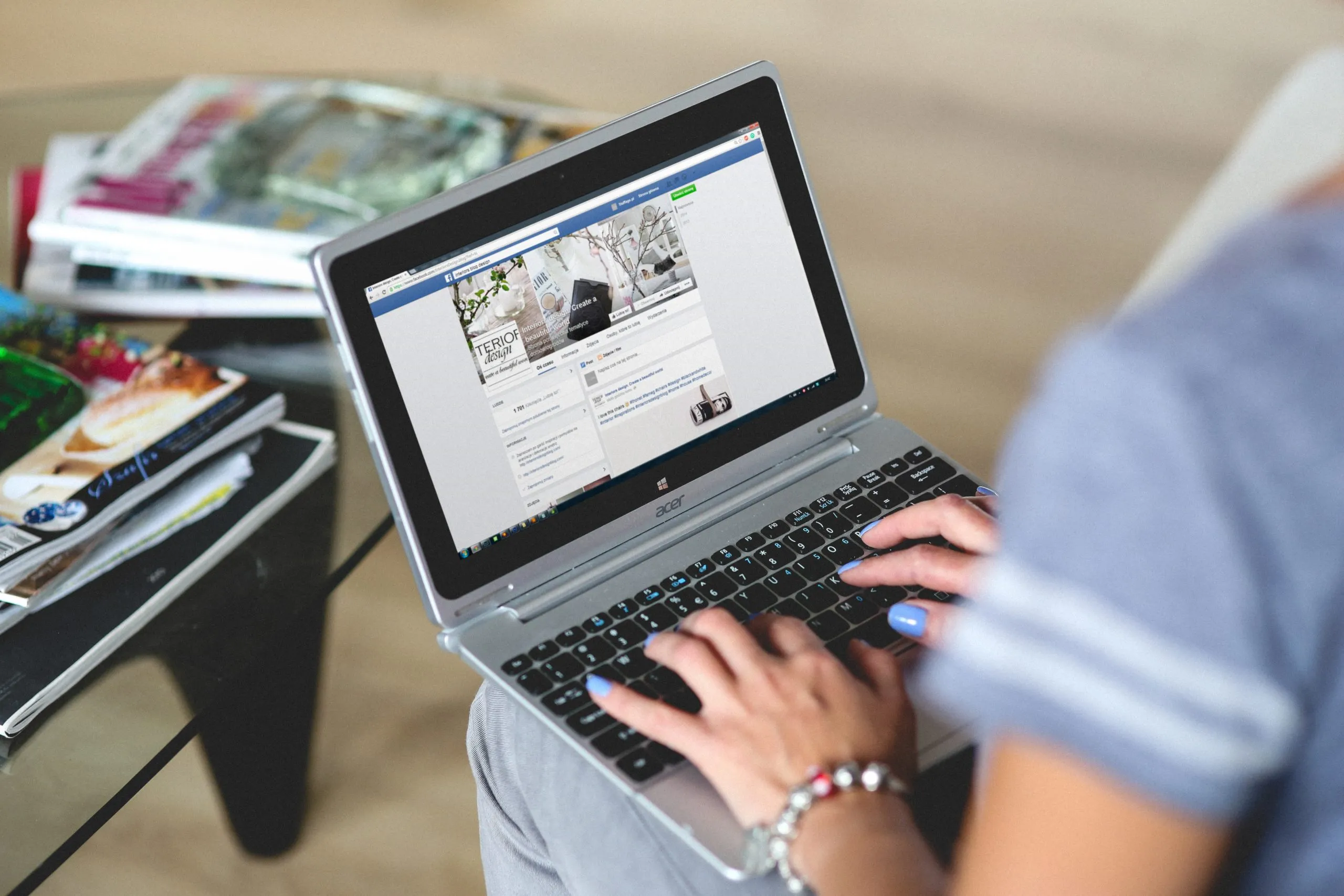 woman using Facebook on laptop