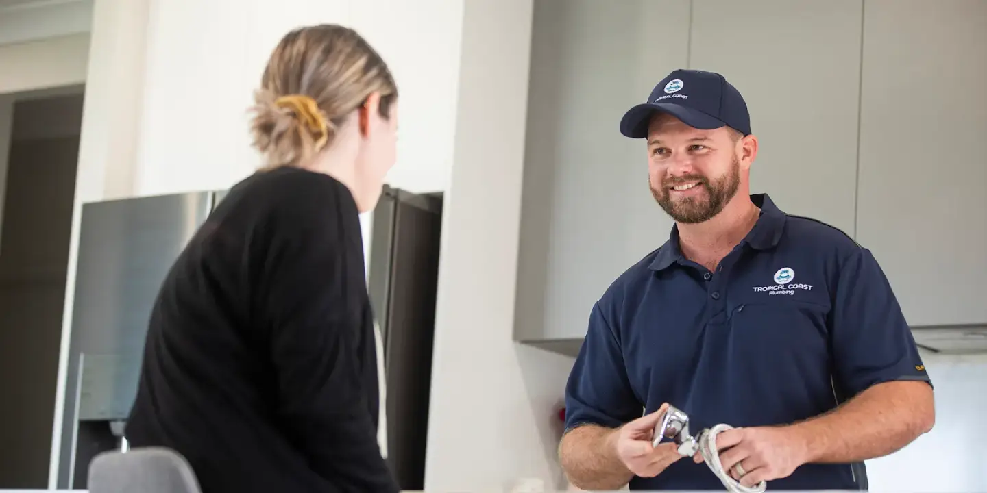 Tropical Coast Plumbing technician discussing blocked drain service options with a homeowner