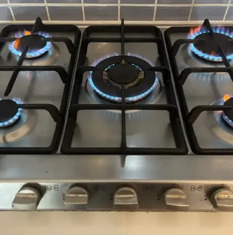 Functional gas cooktop in a Rockhampton home after appliance servicing and safety inspection.