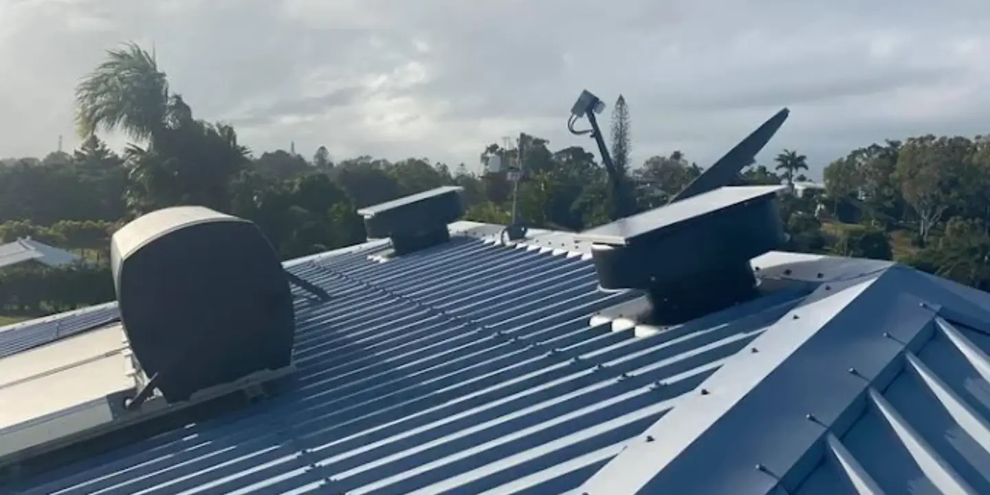 Colorbond roof with ventilation units and solar infrastructure, typical of residential roof structures in Rockhampton.