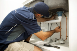 Yeppoon plumber repairing blocked drain pipe under kitchen sink