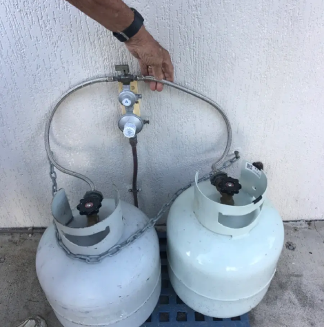Two LPG gas bottles with regulator and hose manifold—residential gas installation setup in Yeppoon