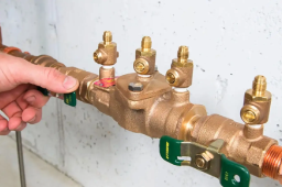 Close-up of a backflow prevention device during inspection, showing valves and test points used in professional backflow testing and compliance services.