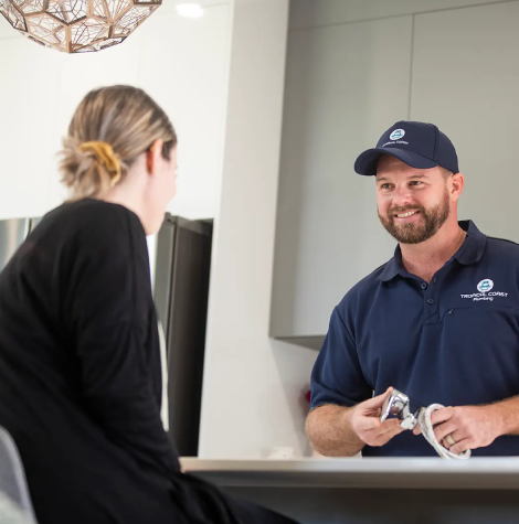 Tropical Coast Plumbing technician speaking with a Yeppoon homeowner about pipe repair solutions and blocked drain services.