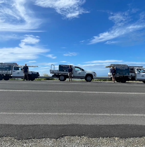 Tropical Coast Plumbing vehicles lined up along the Yeppoon coast, ready to deliver underground pipe locating and detection services across Central QLD.