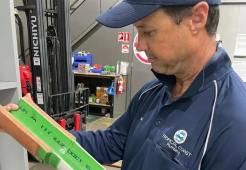 Townsville plumber showing a section of relined pipe, demonstrating the trenchless no-dig repair process used for damaged pipes.