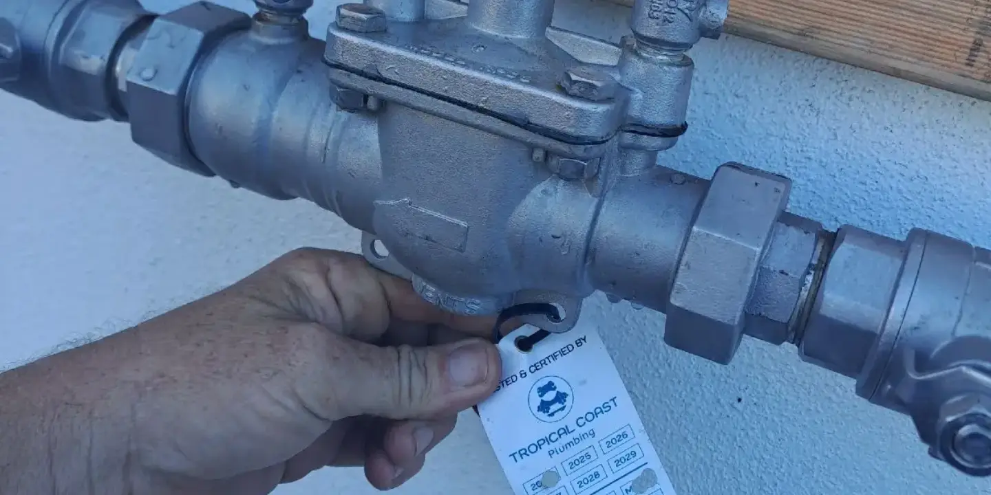Licensed plumber inspecting and certifying a gas line valve in Townsville for safe operation and scheduled gas maintenance services.