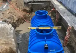 Townsville plumber repairing sink drainage connected to a grease trap system, preventing leaks, blockages, and sewage issues.