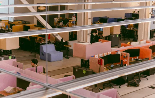 Discord’s office — a comfortable arrangement of various seating options, computer equipment, individual desks, and Discord employees at work.