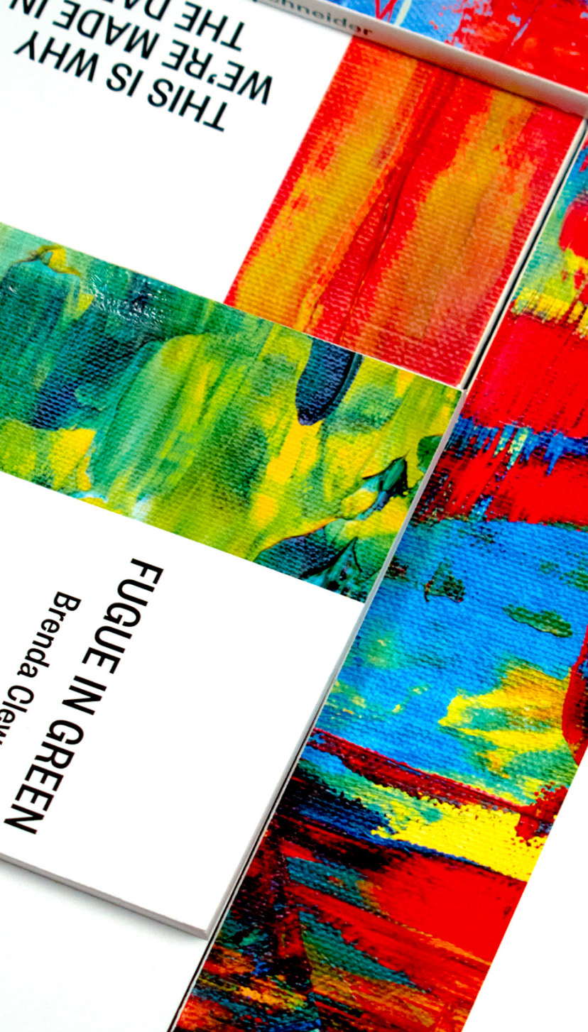 Photograph of multiple book covers placed to cover the image. Taken from a bird's eye view.