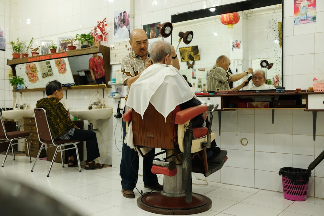 man giving haircut at salon