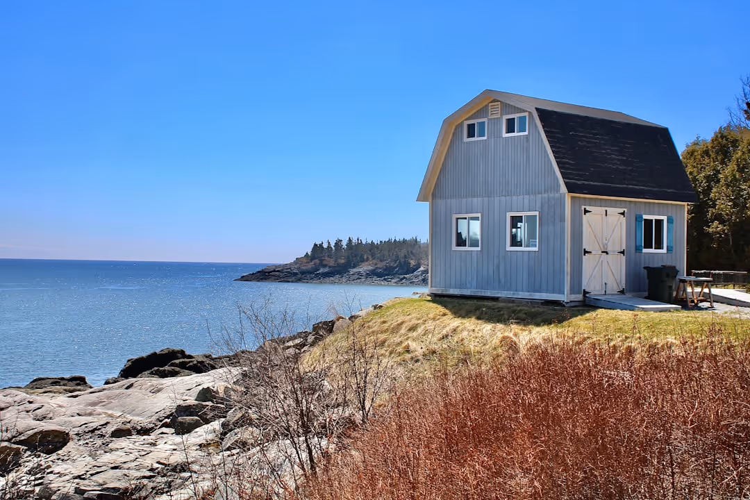 A coastal home during a sunny day in Wells, Maine, highlighting its serene but potentially vulnerable location - Insurance Kennebunk Maine