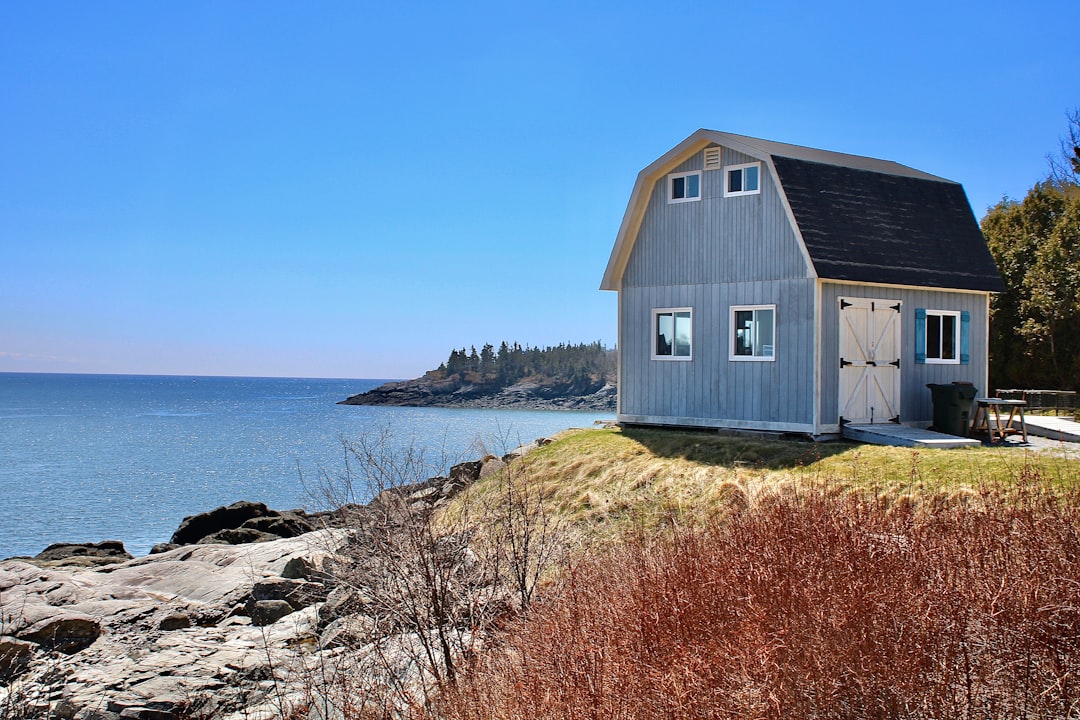 A coastal home during a sunny day in Wells, Maine, highlighting its serene but potentially vulnerable location - Insurance Kennebunk Maine