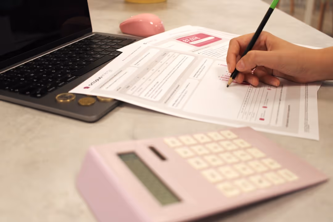 Person reviewing a car loan document with a calculator - Gap insurance for new car Person reviewing a car loan document with a calculator - Gap insurance for new car