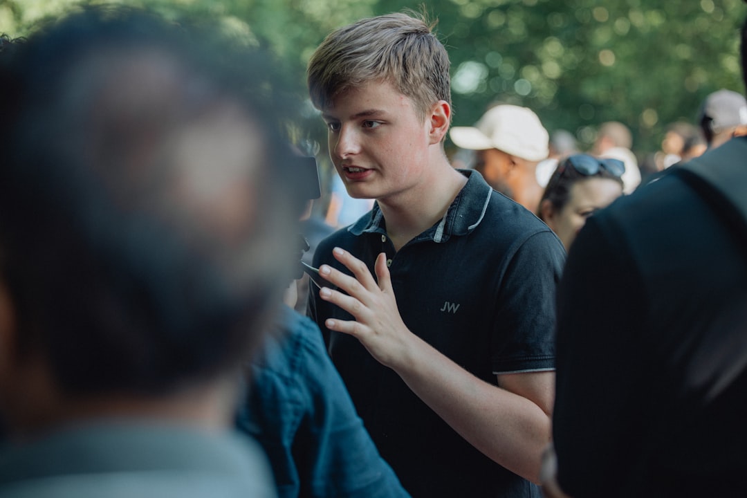 young man talking to agent - cheapest car insurance for young men