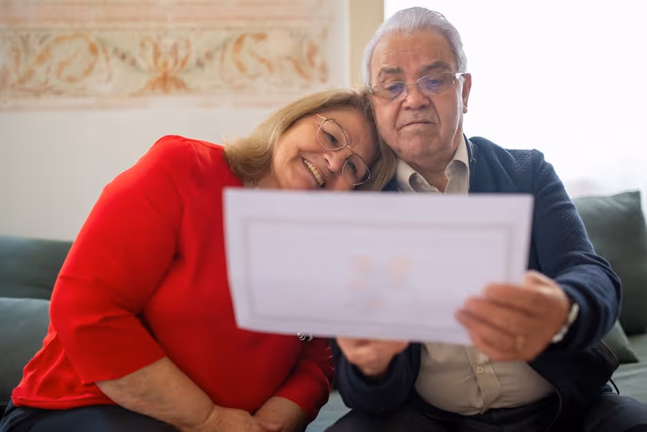 A family happily reviewing an insurance document together in their cozy living room, highlighting the peace of mind that comes with understanding your policy. - Home insurance Portland