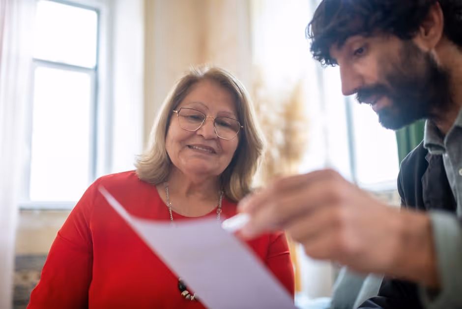 Friendly insurance agent meeting with a client in an office setting in Southern Maine - Auto insurance policy review Friendly insurance agent meeting with a client in an office setting in Southern Maine - Auto insurance policy review