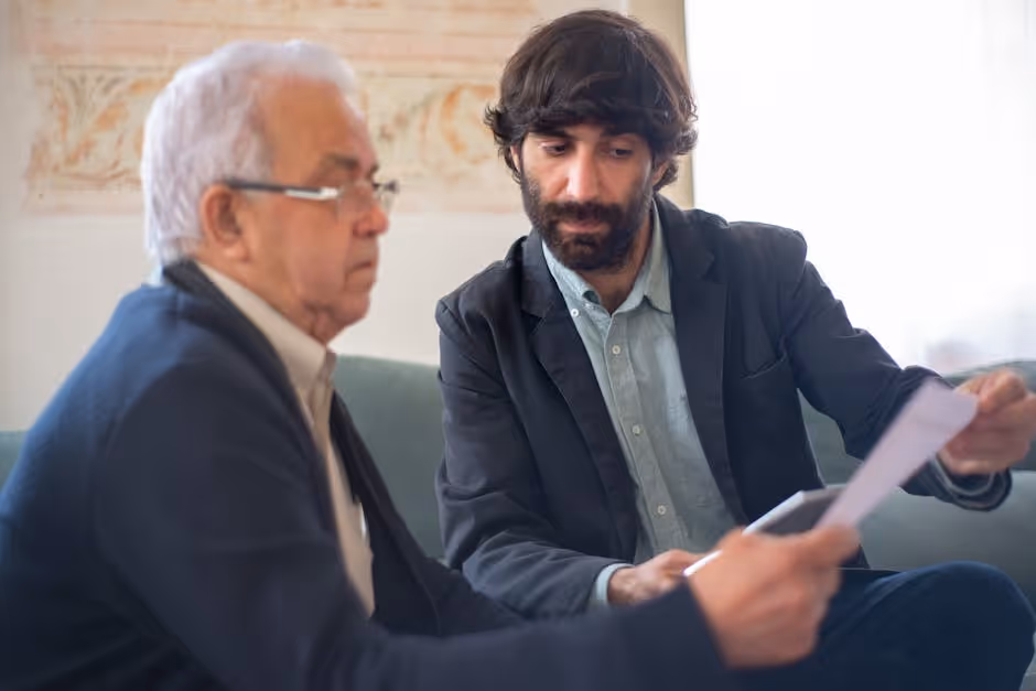 business owner reviewing paperwork with an insurance agent - small business insurance business owner reviewing paperwork with an insurance agent - small business insurance