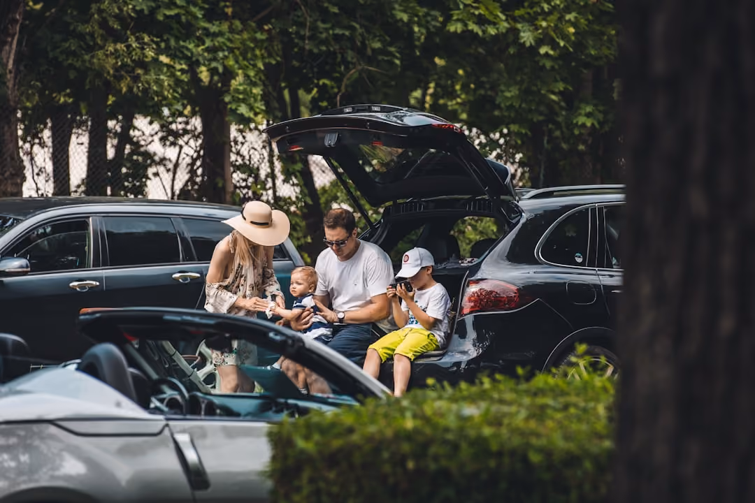 A happy family packing their SUV for a summer weekend road trip in Wells, Maine A happy family packing their SUV for a summer weekend road trip in Wells, Maine