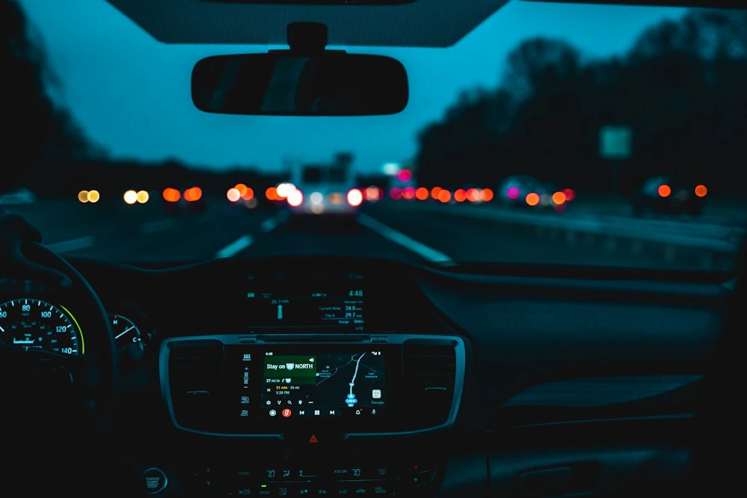 High risk auto insurance car driving along scenic Maine coastline