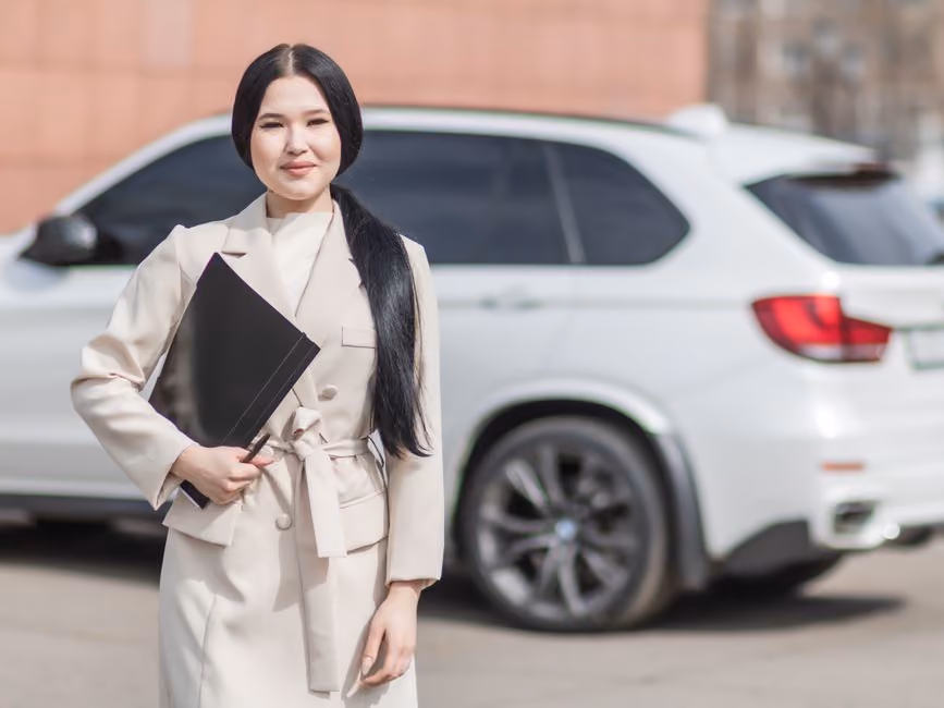 young driver in front of car - best car insurance for 21 year olds concept
