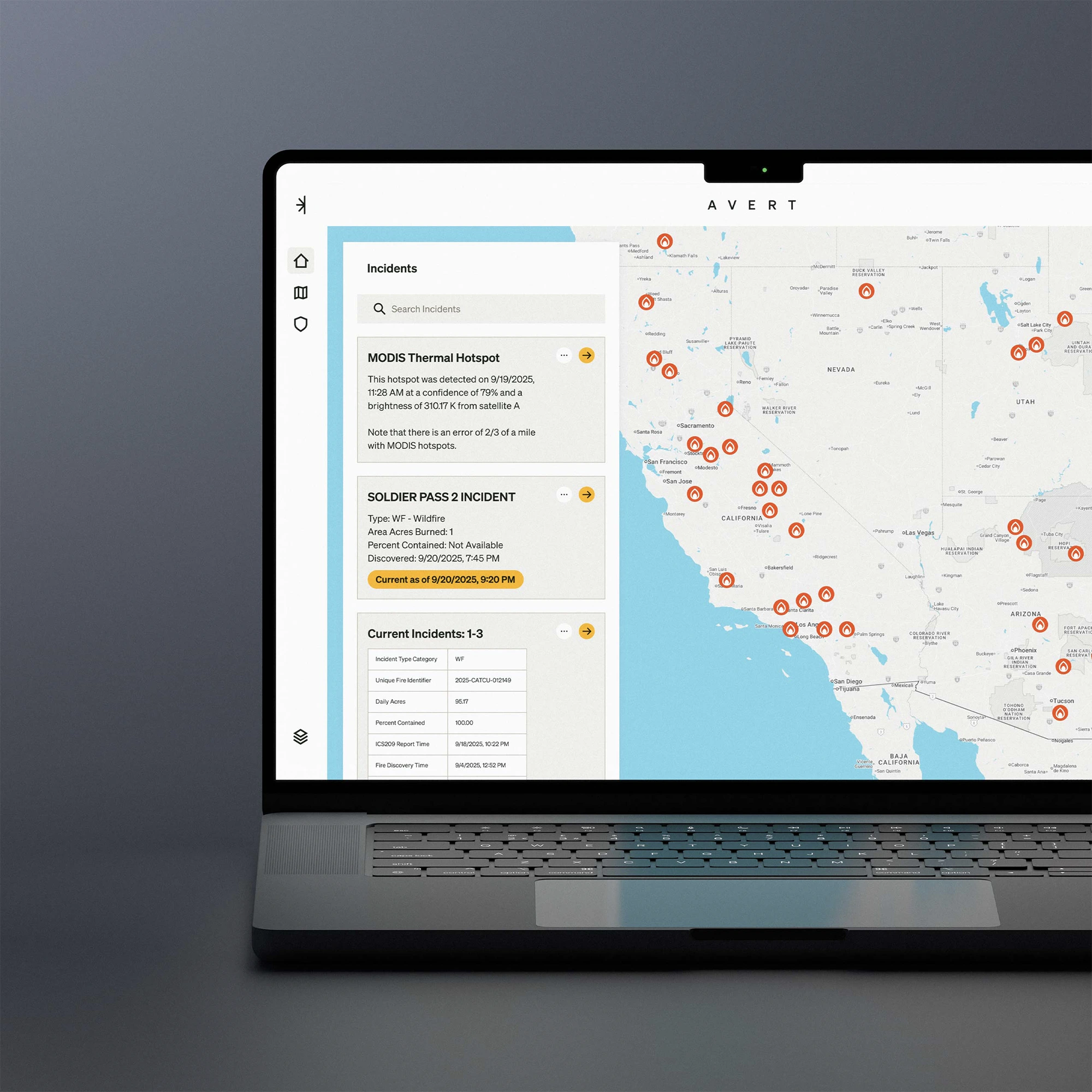 Laptop displaying a wildfire incident tracking map of California and surrounding states with multiple fire icons and incident details on the left panel.