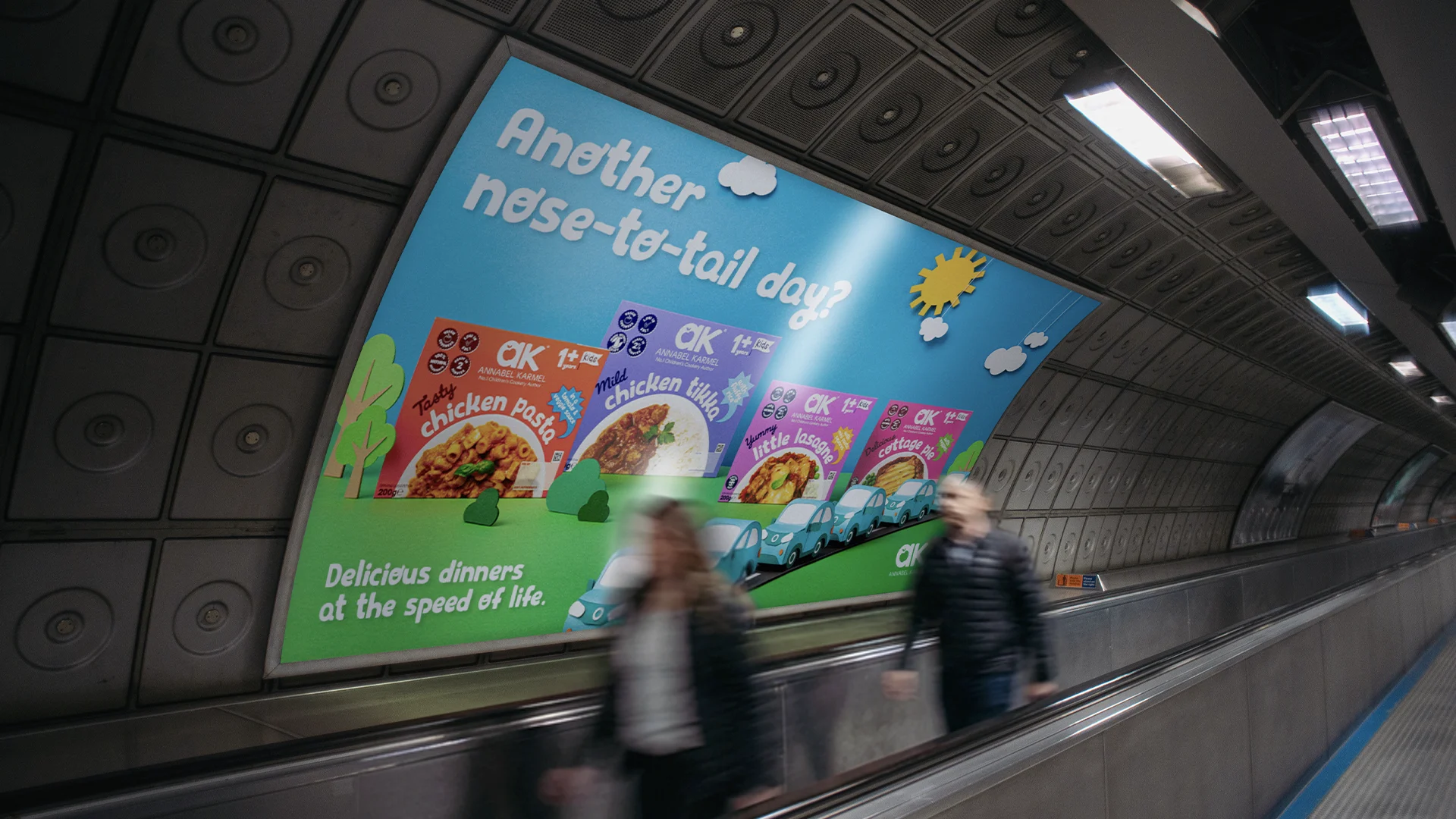 Subway tunnel advertisement for Annabel Karmel kids' meals featuring chicken pasta, chicken tikka, little lasagne, and cottage pie with the text 'Another nose-to-tail day? Delicious dinners at the speed of life.'