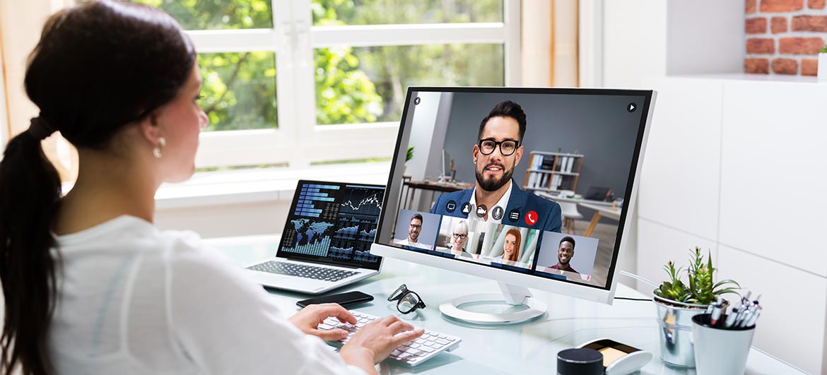 Femme en visioconférence face à son interlocuteur sur un écran d'ordinateur