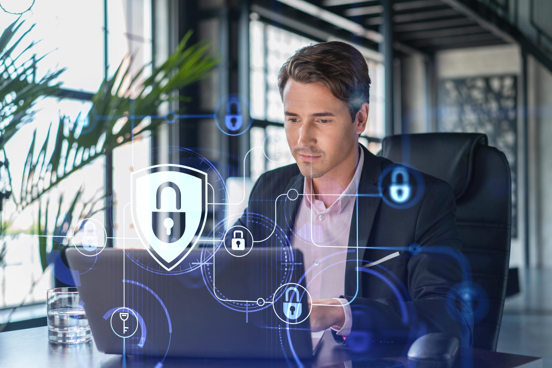 Homme travaillant sur un ordinateur portable entouré d'icônes de cybersécurité