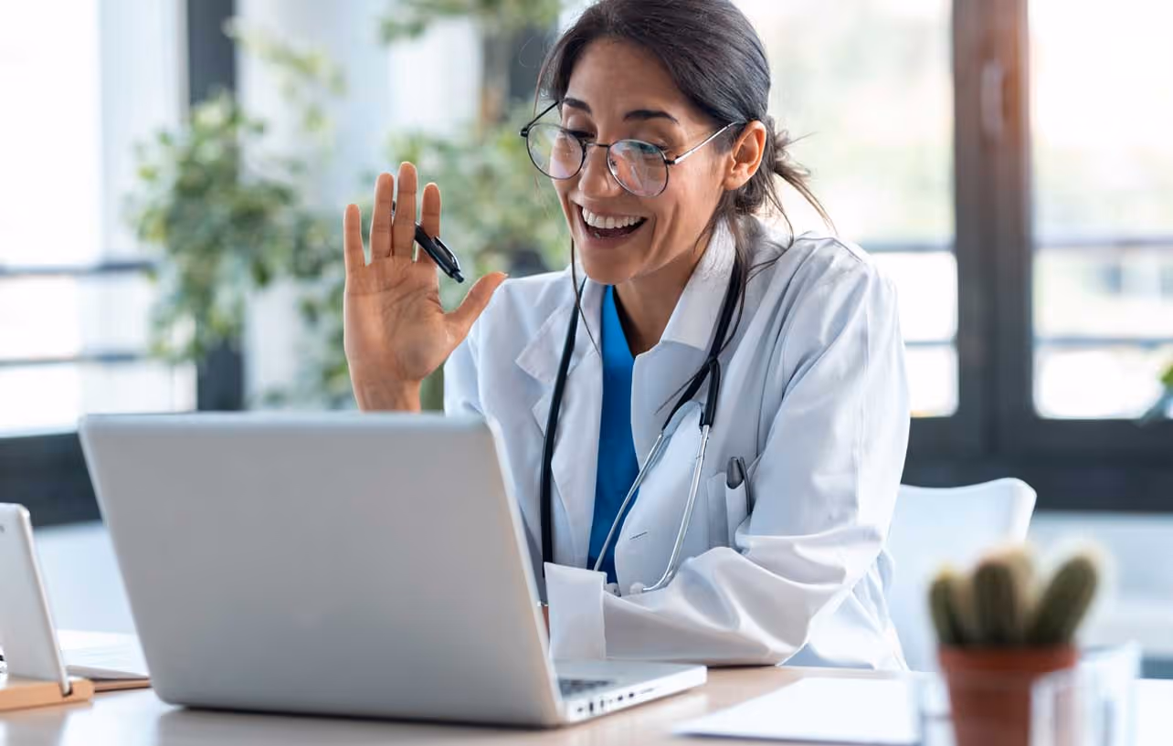 medical doctor talking with patient via laptop