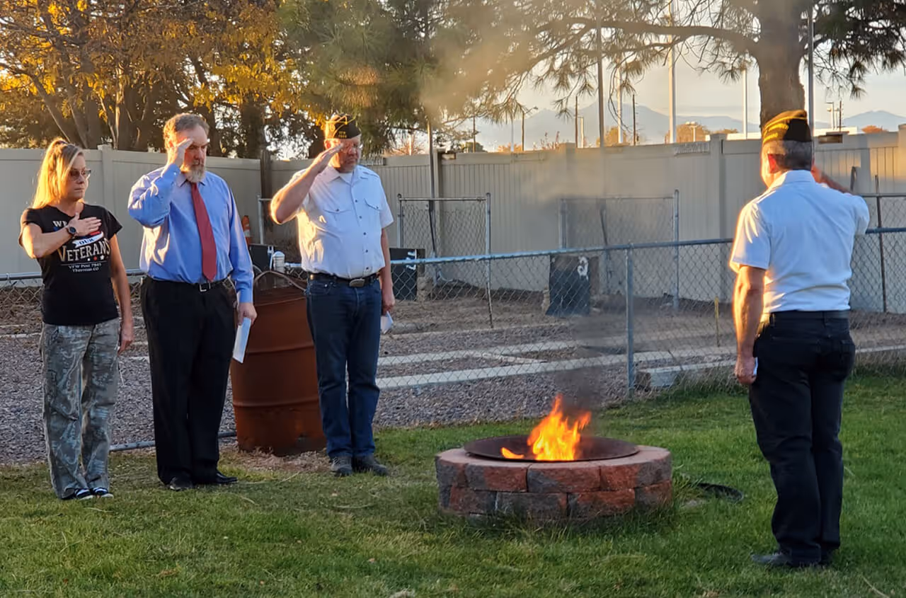 people saluting firepit in honor of fallen veterans