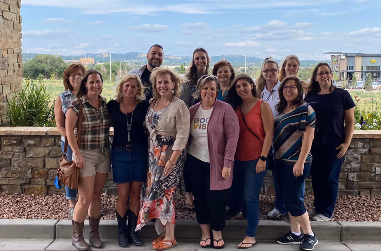 caption first team outing - standing outside of hotel