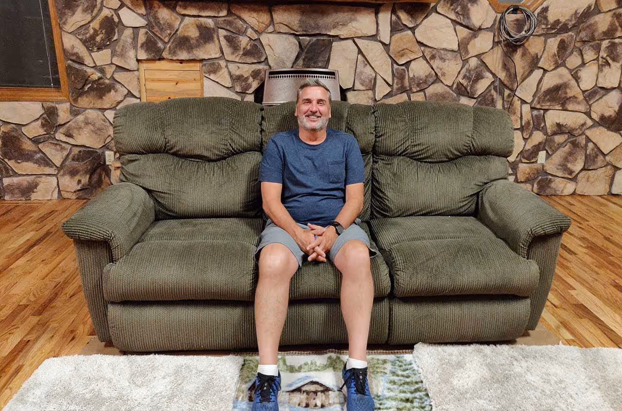 caption first team outing - man sitting on couch
