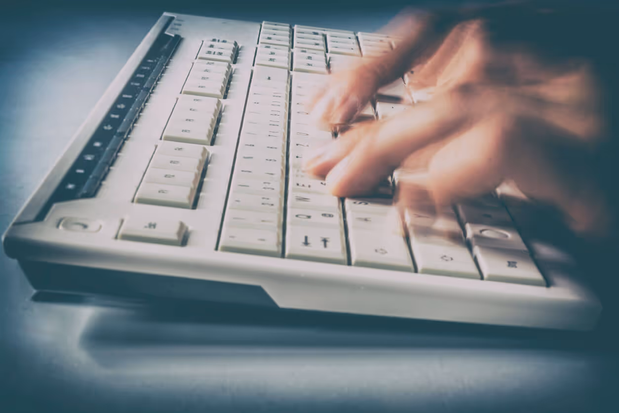 closeup of hand typing on keyboard