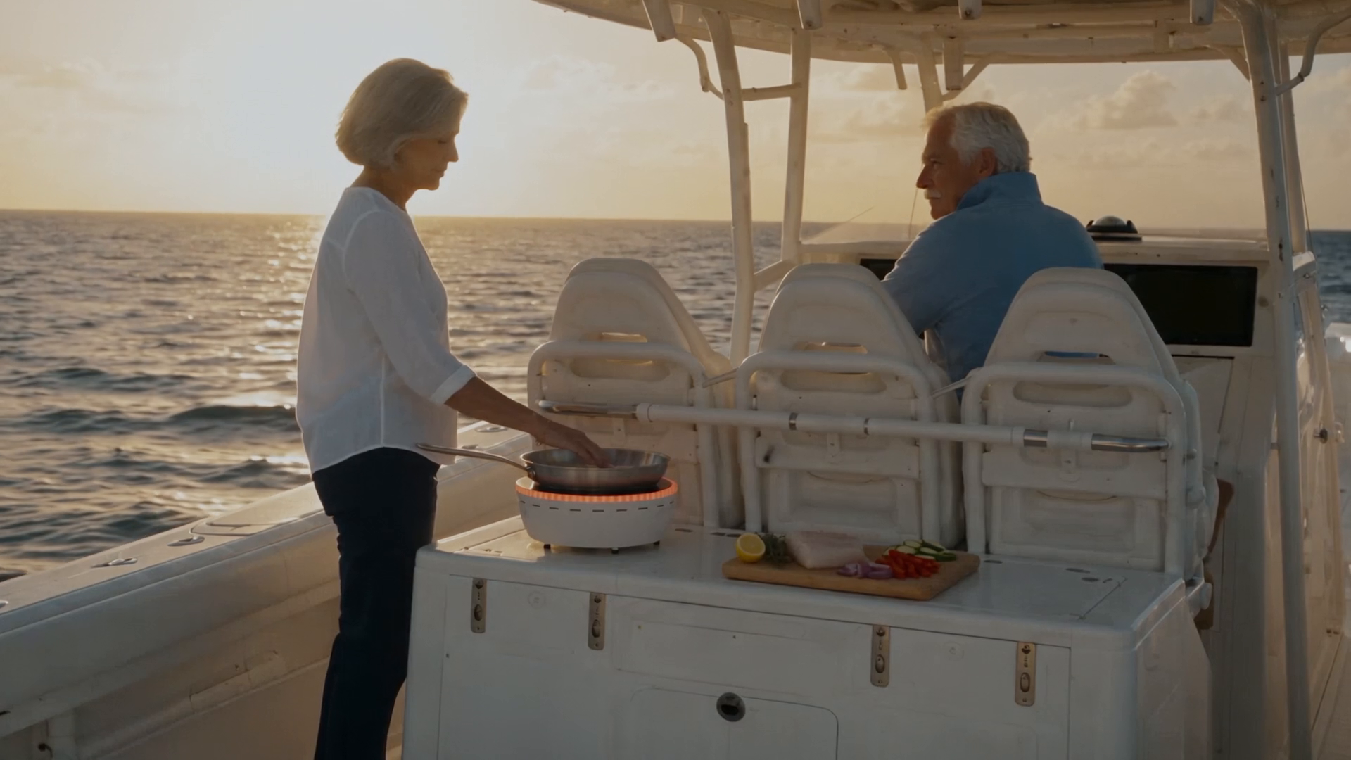 Cooking on Chef aboard a boat at sunset