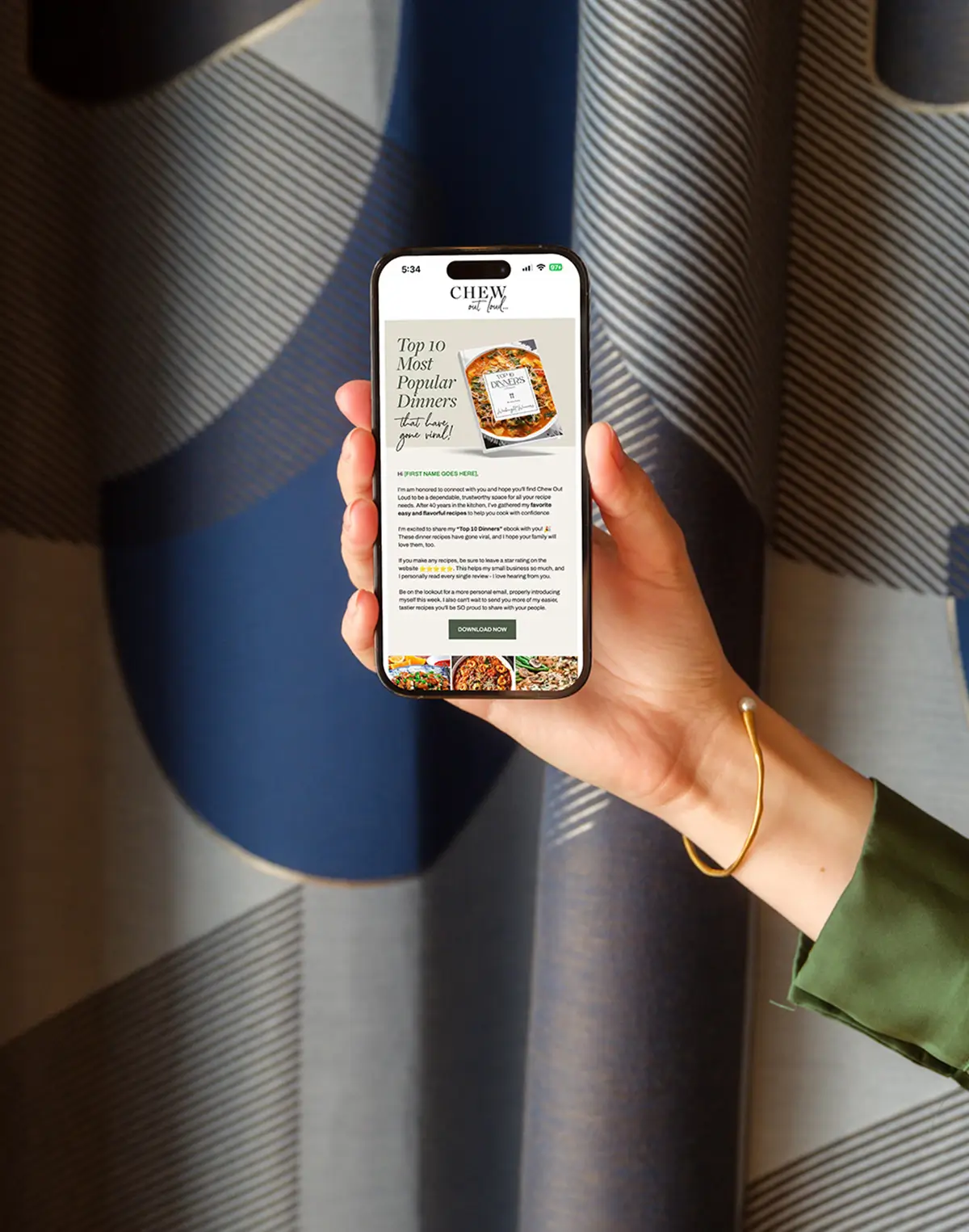 Email design on an iPhone in front of curtains