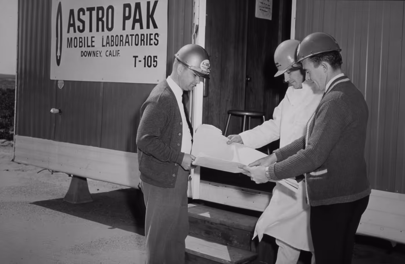a team form astropak working together in front of a mobile lab