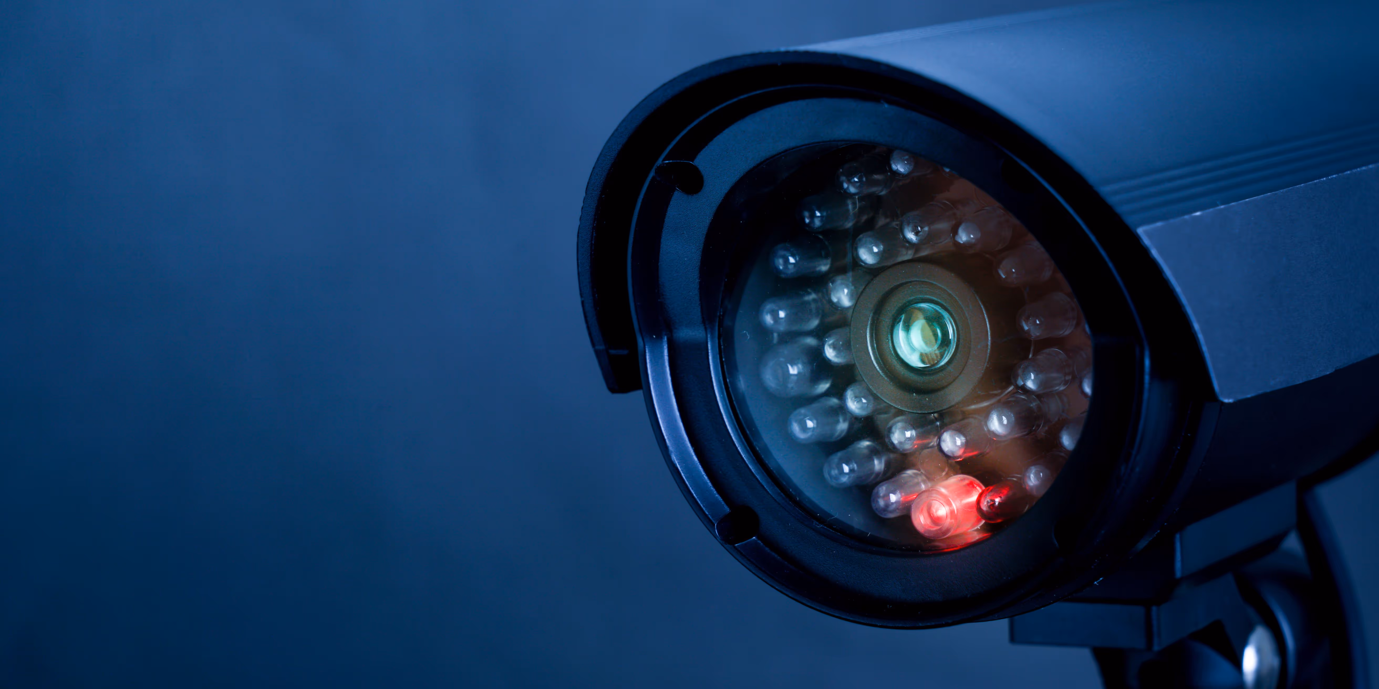 Close up of a security camera against a dark background