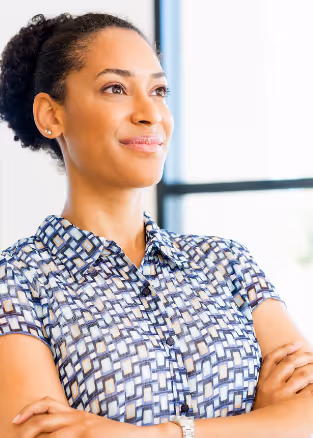 Professional woman with her arms crossed looking into the distance